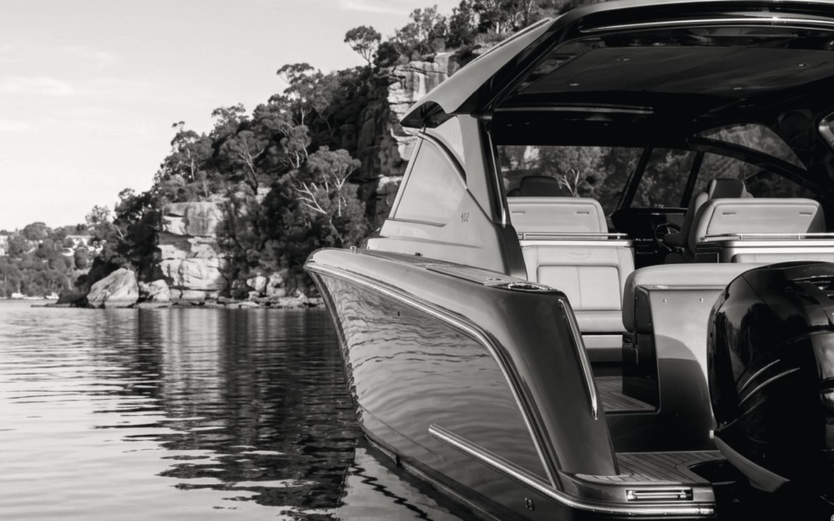 Open cockpit and helm seating of a sports cruiser at rest in a sheltered bay